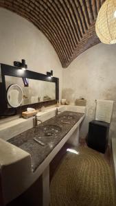 a bathroom with a sink and a mirror at villa lalla Ourika & heated pool in Aghbalou +51 photos