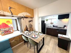 a small kitchen with a table in a room at K-ART Stay Shinsakae2 in Nagoya
