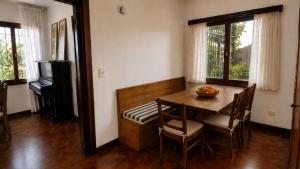 a dining room with a table and chairs and a television at Centrally located lakefront house in San Carlos de Bariloche
