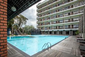 a large swimming pool in front of a building at Mesra International Hotel in Samarinda