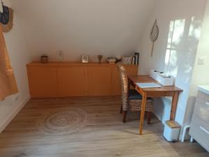 a room with a desk and a table with a chair at Maison des bois in Neufchâtel-Hardelot +2 photos