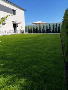a large lawn in front of a house at Stay Inn in Galaţi +38 photos
