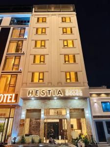a hotel building with a sign in front of it at Hestia Hotel Móng Cái in Móng Cái