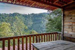 a porch of a cabin with a view of the mountains at Colibri - Cabañas Puerto del Zopilote in Pinal de Amoles
