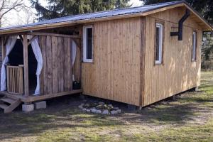 a wooden shed with a door and a window at Agroturystyka Ranczo u Oli in Krynki Białokunki