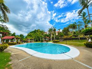 a swimming pool at a resort with palm trees at Graceland Resort Tayabas Quezon in Tayabas +12 photos