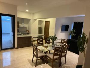 a dining room and kitchen with a table and chairs at Departamento Torre el Morado MAS EXPERIENCIA A CABALLO in La Concepción +7 photos