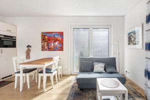 a living room with a blue couch and a table at Ferienwohnung Am Hochrhein in Murg