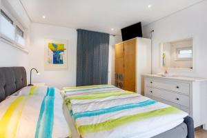 a bedroom with a bed and a dresser at Ferienwohnung Am Hochrhein in Murg