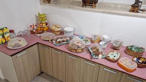 a kitchen counter with a table with food on it at B&B La Filanda in Scilla