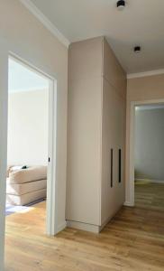 a bedroom with a bed and a white cabinet at Жк "AUEZOV" in Kokshetau