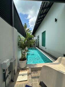 a swimming pool in the middle of a building at The Lumber with Private Pool in Masjid Tanah