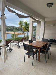 a wooden table and chairs on a patio at Apartment Tranquillo in Vela Luka