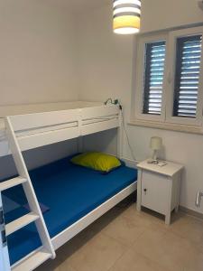 a bedroom with a bunk bed with a ladder at Apartment Tranquillo in Vela Luka