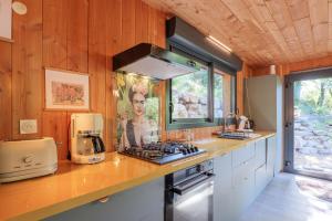 a kitchen with a counter with a stove and a microwave at Casa Frida in Salavas +16 photos
