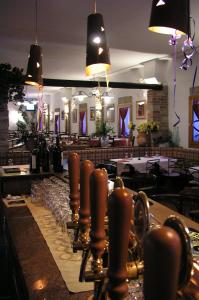 a bar with a long row of wine glasses at Hotel Al Barco in Santo Stino di Livenza