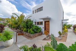 a white house with plants in front of it at Legendary Zanzibar Beach Resort in Michamvi