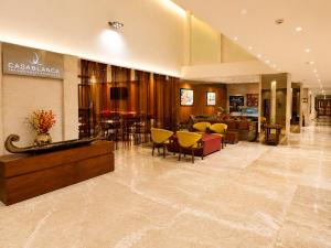 a lobby with chairs and tables in a store at Pride Premier Pune in Pune +66 photos