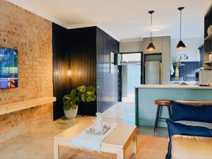 a living room with a table and a kitchen at Fine Stay Clarens in Clarens