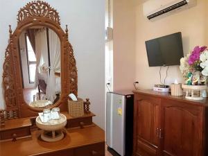 a room with a mirror and a sink and a refrigerator at Baan Buapatumma in Mae Sai +17 photos