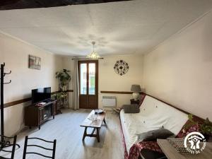 a living room with a couch and a table at Al clouc in CampÃ´me