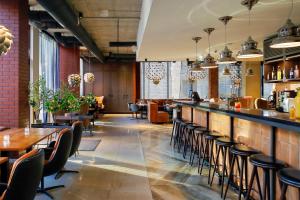 a restaurant with tables and chairs and a bar at Metropol Spa Hotel in Tallinn