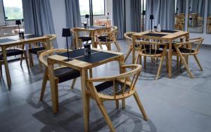 a group of tables and chairs in a restaurant at The Ridge Guesthouse in Richards Bay