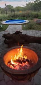 a fire pit with flames in a brick yard at Zebra game farm in Brits