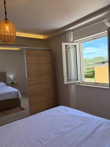 a bedroom with a bed and a window at Apartment Cascades in Trogir