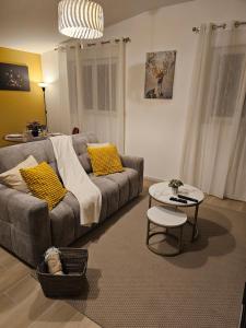 a living room with a couch and a table at Le Nid De Mouroux - Disney 20 min - Clim & Parking in Mouroux