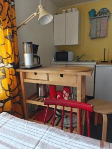 a small kitchen with a table and a counter top at Päivärannantila in Pihtipudas