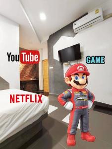 a video game room with a mario character in a bedroom at Hoft Hotel Ramkhamhaeng24 in Sathani Khlong Tan