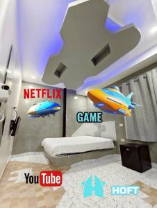 a bedroom with a bed and a game sign on the wall at Hoft Hotel Ramkhamhaeng24 in Sathani Khlong Tan
