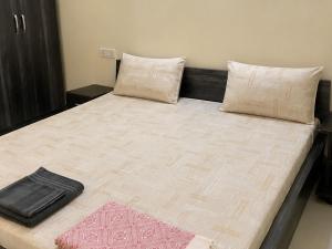 a large bed with two pillows on top of it at Hiran Holidays in Sasan Gir +24 photos