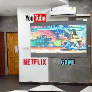 a wall with a video game sign on it at Hoft Hotel Ramkhamhaeng24 in Sathani Khlong Tan