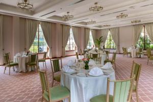 a banquet room with tables and chairs and windows at DLF Club 3 in Gurgaon +32 photos