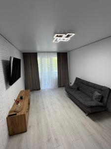 a living room with a couch and a table at Premium 2-Room Rental in Bălţi