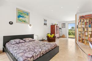 a bedroom with a large bed and bookshelves at Chambres D’hôte Cotignac in Cotignac