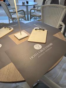 a table with a sign on top of it at Hotel Grottamare in Lido di Jesolo