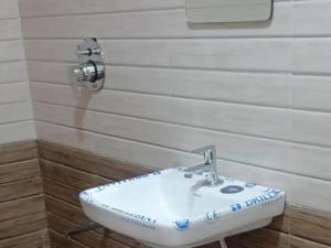 a bathroom with a sink on the wall at Hiran Holidays in Sasan Gir