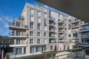 an apartment building with balconies on the side at DOMITYS - Les Canotiers in Argenteuil