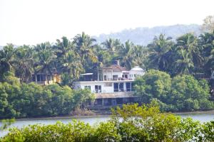 a house on the banks of the river at Riverfront By Gikijoy in Agarvado