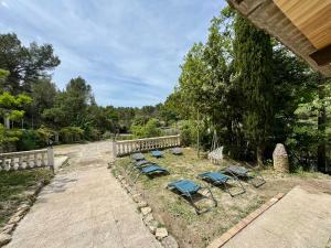 a group of chairs and lawn chairs in a yard at Maison en campagne in Salon-de-Provence