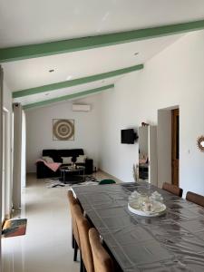 a dining room with a long table and chairs at Maison en campagne in Salon-de-Provence