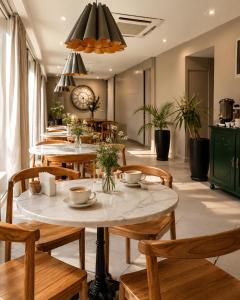 a dining room with wooden tables and chairs at Armonium Airport in Ezeiza