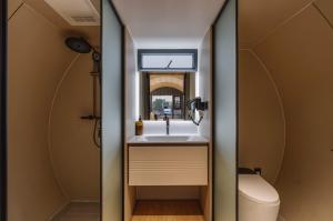 a bathroom with a sink and a toilet at Anchaviyo Resort in Vāda +88 photos