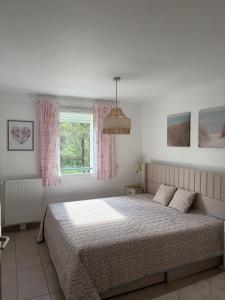 a bedroom with a bed and a window at Appartement Belle Vue in Gréoux-les-Bains