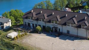 a large white building with a bunch of roofs at Villa Dobry Adres in Dziemiany