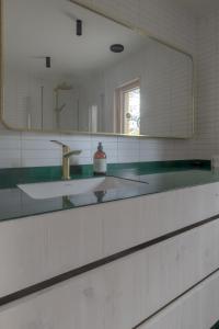 a bathroom with a sink and a mirror at Bratt bolig in Åndalsnes +64 photos