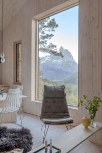 a room with a chair and a large window at Bratt bolig in Åndalsnes